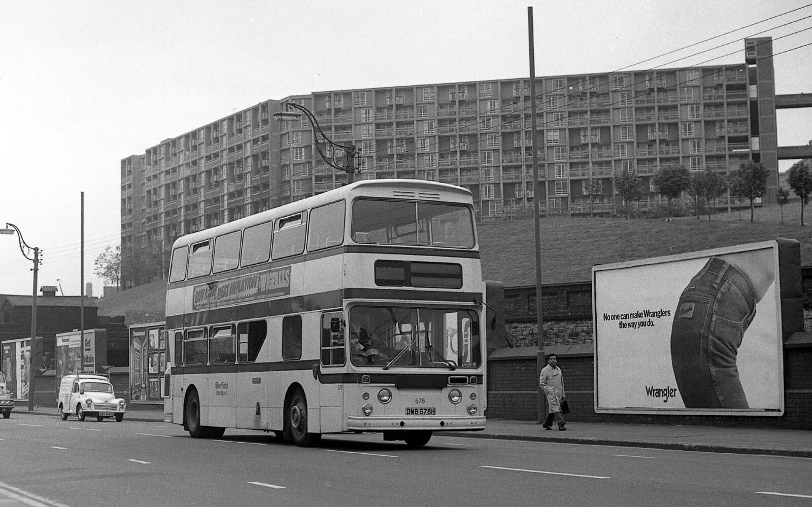 Black and white picture of double decker bus in front of park hill