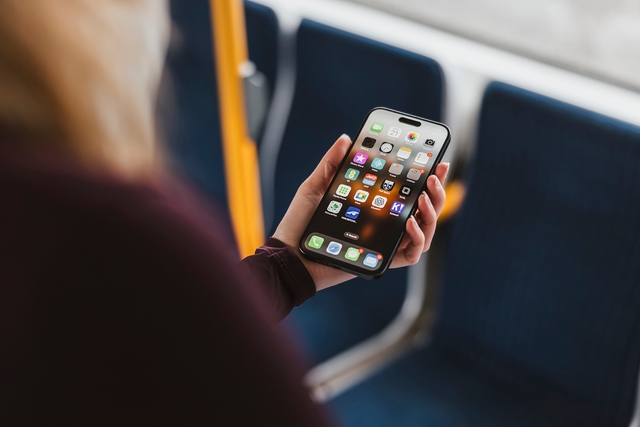 Woman using her mobile phone on a tram.